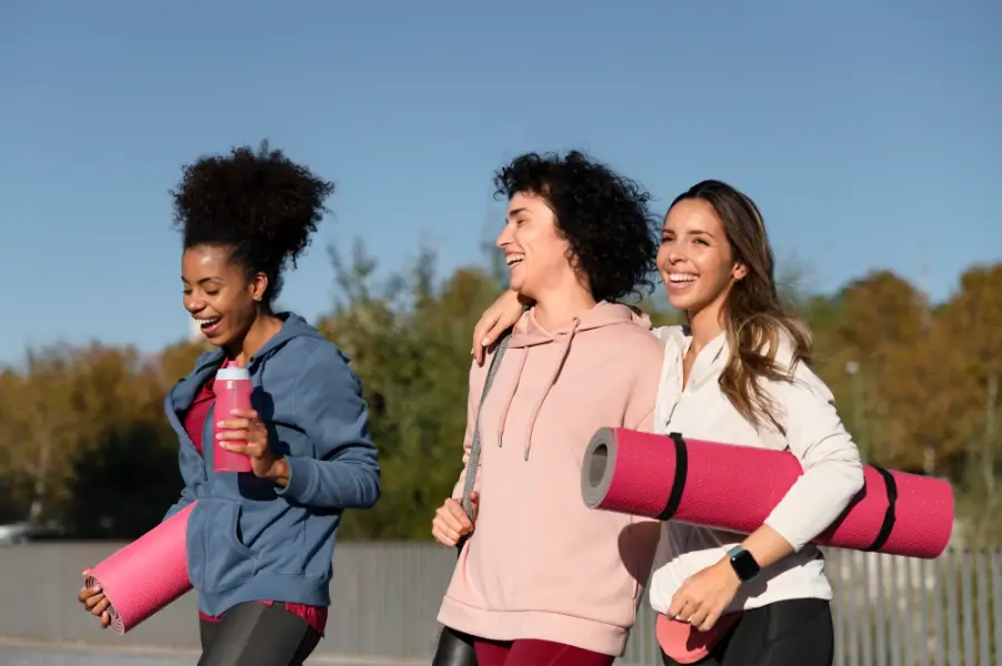 Medium shot women with yoga mats